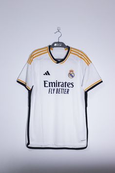 the jersey worn by real madrid's team is hanging on a hanger in front of a white wall