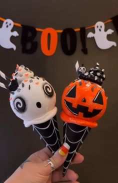 two ice cream cones decorated with halloween decorations