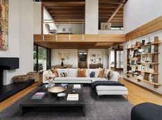 a living room filled with furniture and a fire place in the middle of a room