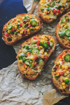 several pieces of bread with various toppings on them