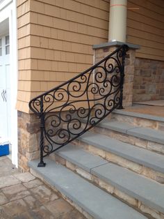 a wrought iron stair rail on the side of a house