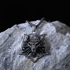 This Witcher Wolf Necklace is a stunning piece of handmade jewelry, perfect for any lover of animal-inspired accessories. Made from high-quality 925 sterling silver, the wolf head pendant is expertly crafted to create a lifelike and detailed representation of this magnificent creature. This necklace is an ideal gift for Father's Day or any special occasion for men. With its rugged charm and striking design, it's sure to make a statement and become a treasured addition to any jewelry collection. Witcher Jewelry, Sterling Silver Wolf Design Necklace As Gift, Men Wolf Necklace, Nordic Wolf Necklace, Silver Wolf Pendant Necklace, Wolf Necklace, Wolves Pendants, Silver Wolf, Silver Necklaces Women