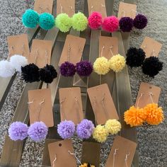 many different colored pom poms are on display