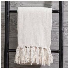 a white towel hanging on a black ladder