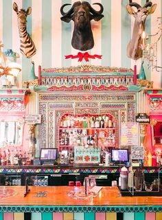 a brightly colored bar with deer heads on the wall