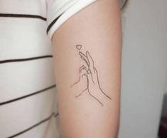 a woman's arm with a small tattoo on the left side of her arm