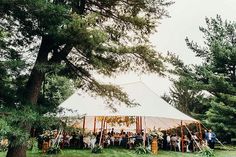 a group of people standing around a tent