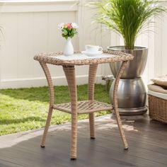 a wicker table with two cups on it