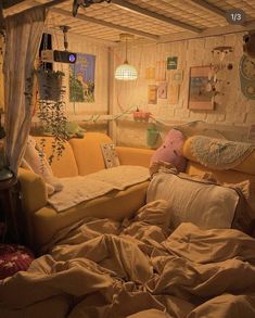 an unmade bed with lots of pillows on it