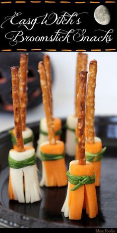 halloween treats made out of cheese sticks and carrots on a black plate with the title easy witch's broom broom snacks