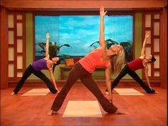 a group of women doing yoga poses in front of a tv