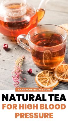 a cup of tea with orange slices and cranberries next to it on a wooden table