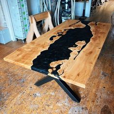 a wooden table with black paint on it