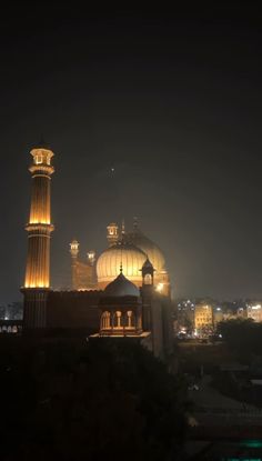 an image of a building that is lit up in the dark night sky with lights on it