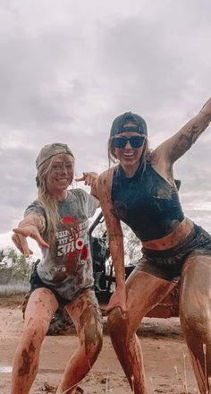 two women are playing in the mud together