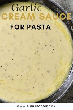 a pan filled with cream sauce on top of a table