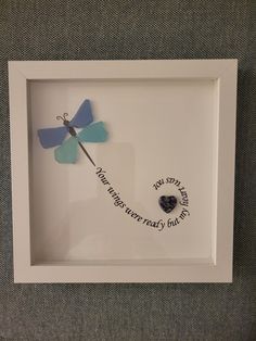 a blue and green dragonfly in a white shadow box with the words, i love you so much