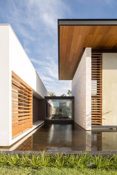 the entrance to a modern house with wood slats