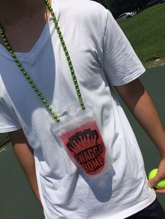 a young man holding a tennis ball and racquet