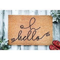 a door mat with the words hello and hello written on it next to red shoes