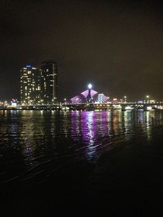 the city lights shine brightly over the water