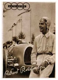 an old photo of a man standing next to a car