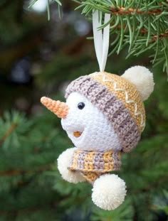 a crocheted ornament hanging from a tree with the text joy the snowman, crochet pattern