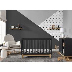 a baby's room with grey walls and white furniture, including a crib