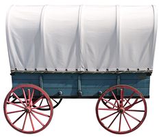 a blue and white covered wagon with red wheels on a white background stock photo getty images