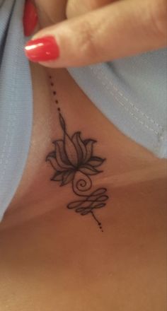 a woman's neck with a flower tattoo on it