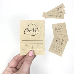 someone holding up some business cards with the word crockett written on them in cursive writing