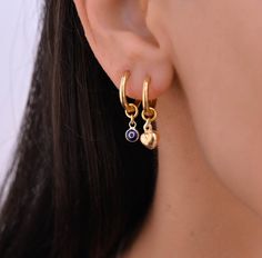 These small hoop earrings are a set of 2 mismatched huggie hoop earrings. The one earring has a evil eye charm on it while the other has a gold charm.  Any combination of hoop is available. Hoops - Gold plated surgical stainless steel Charms - gold plated sterling silver 925 Gold Hoop Dangle Earrings, Gold Hoops With Charms, Charm Hoop Earrings, Double Earrings Combinations, Curated Ears, Hoop Earrings With Charm, Hoops With Charms, Gold Huggie Hoop Earrings, Hoop Earring Set