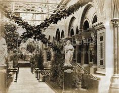 an old black and white photo of the inside of a building with statues in it