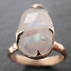 I created this setting in wax then cast it in recycled solid 14k gold at my home studio. This ring is a size 7 it can be resized up or down. The stone is rainbow moonstone. it measures about 15mm X 9mm I created a rustic texture in the gold. Throughout all time and history, in every tribe and culture all around the world crystals, minerals and gemstones have used for healing, luck, divination, adornment vibrational medicine and so much more. A stone for new beginnings, Moonstone is a stone of in Unique Moonstone Wedding Ring With Large Stone, Vibrational Medicine, Rustic Texture, Minerals And Gemstones, Soft Natural, Ring Gemstone, Crystals Minerals, Yellow Gold Rings, Rainbow Moonstone