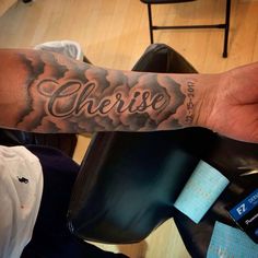 a man's arm with the word cherise tattooed on it