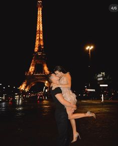 two people are hugging in front of the eiffel tower