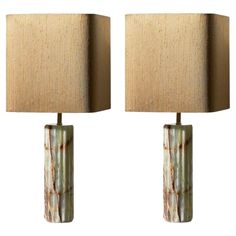 a pair of table lamps with shades on them