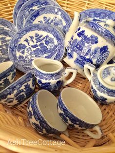 a wicker basket filled with blue and white china