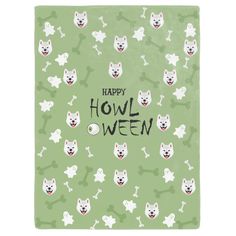 a green towel with white dogs and bones on it that says happy hol ween