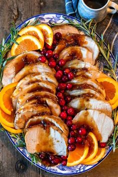 sliced turkey with orange slices and cranberries on a platter