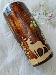 a wooden tumbler with an image of a deer on it