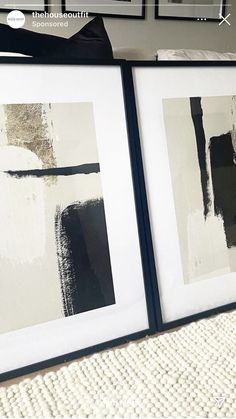 two black and white paintings are on the wall next to each other, one is framed