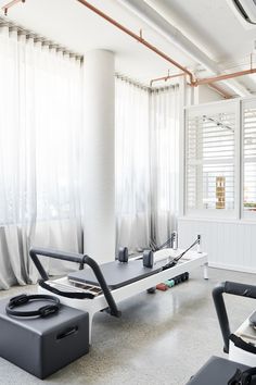 an empty room with several exercise equipment in it