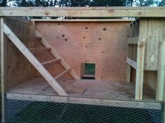 the inside of a chicken coop with stairs