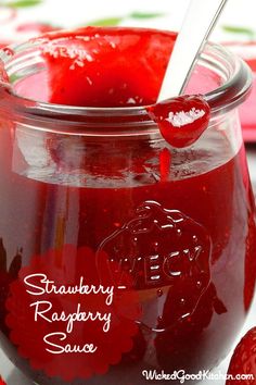 strawberry raspberry sauce in a glass jar with spoon