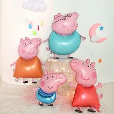 three peppa pig balloons sitting on top of a table