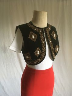 "vintage 1940s bolero style vest dark green velvet shark skin fabric lining steel cut bead detail  gold flecked white medallion detail hook w/loop neck good vintage condition, light wear measures, lying flat, shoulder-15\" armpit to armpit-17 1/2\" (open chest makes more room as well) length-14 1/2\"" Fitted Vintage Vest For Festivals, Eclipse Wedding, 80s Rock Fashion, Shadow Wizard, Velvet Bolero, 70’s Disco, Bolero Style, Shark Skin, Style Inspiration Edgy