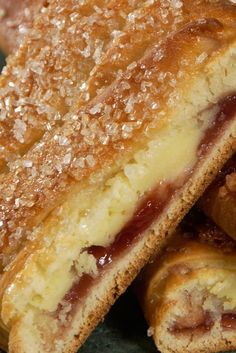 some very tasty looking pastries stacked on top of each other with jelly in them