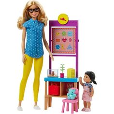 the doll is playing with her toy kitchen