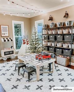 a christmas tree in the corner of a room with toy cars and toys on the floor